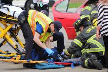 Medic and firefighter at a crash scene.
