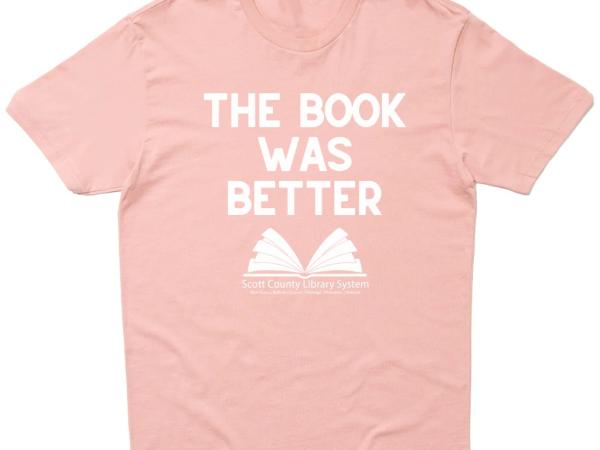 This is a desert pink shirt that says The Book Was Better. 
